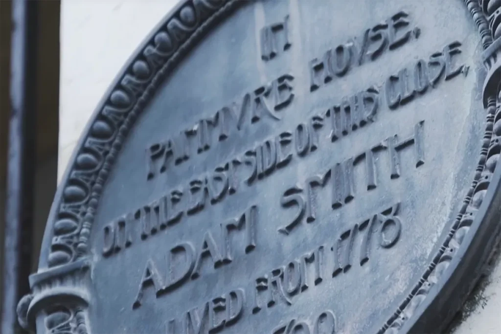 Close-up of a historical plaque marking the residence of Adam Smith, noting his years of life from 1723 to 1790.