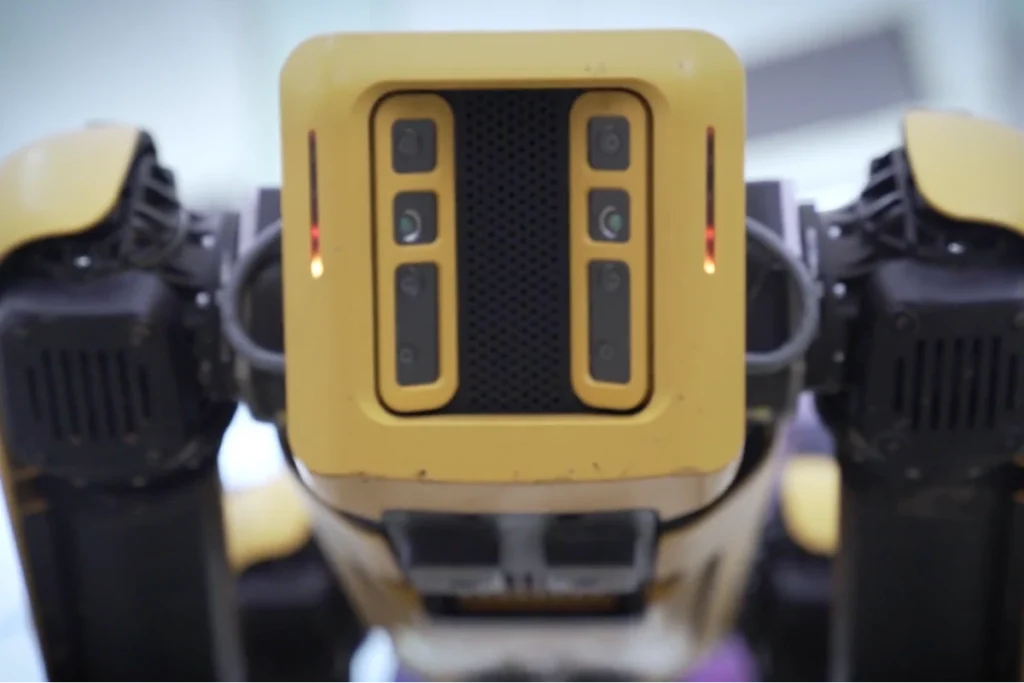 Close-up view of a robotic device featuring cameras and sensors, showcasing advanced technology and design in robotics.